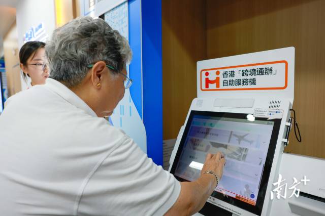香港市民尝试使用香港“跨境通办”自助服务机。 