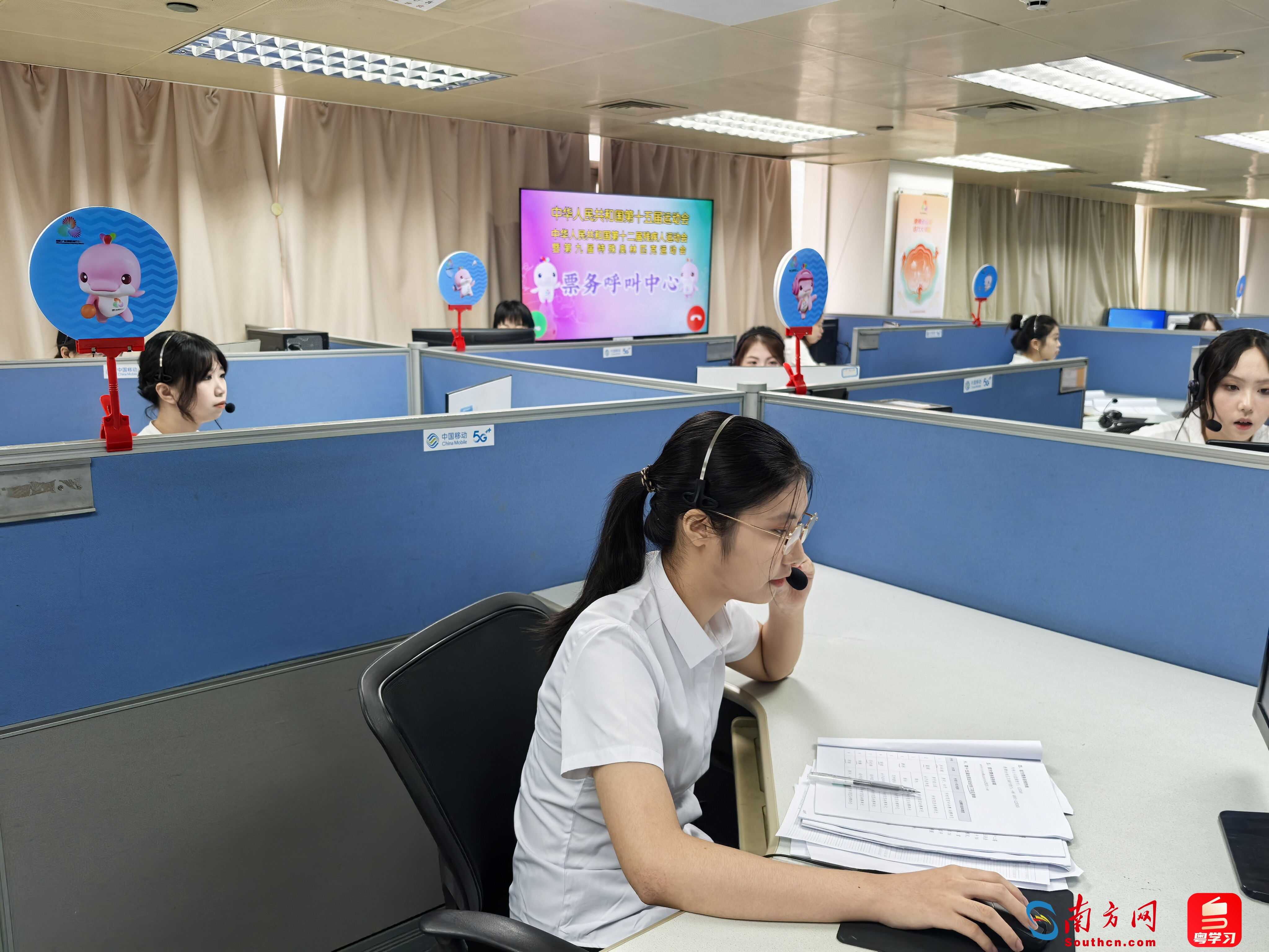 在十五运会和残特奥会票务呼叫中心，工作人员正在接听公众来电